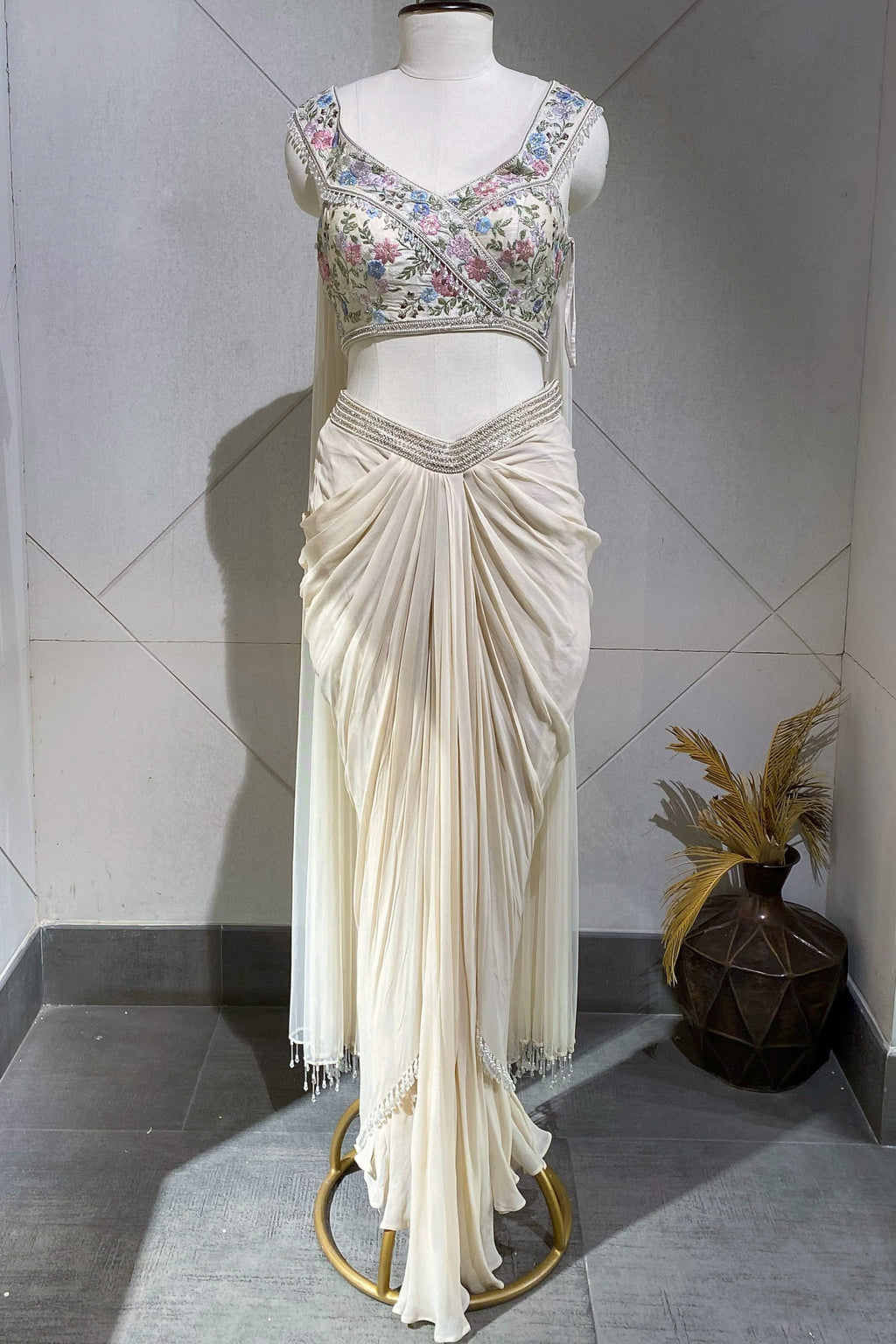 Shop a beautiful off-white fusion saree featuring embroidery and peal work. Make a fashion statement on festive occasions and weddings with designer sarees, designer suits, Indian dresses, Anarkali suits, palazzo suits, designer gowns, sharara suits, and embroidered sarees from Pure Elegance Indian fashion store in the USA.