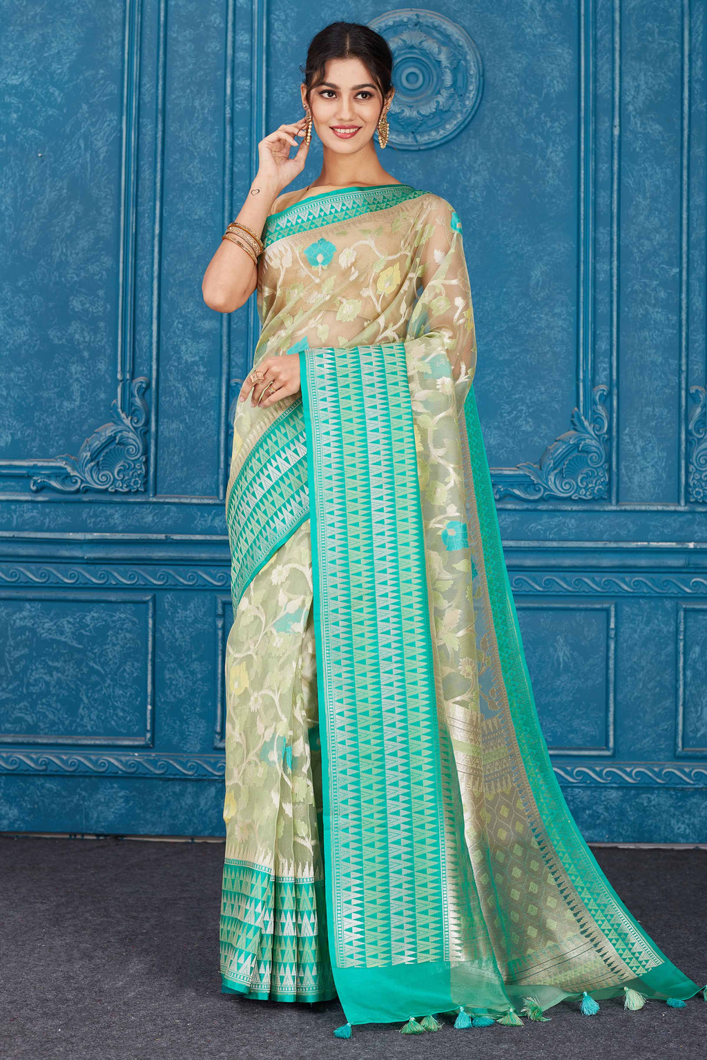 Buy beautiful beige Kora Banarasi sari online in USA with green border. Look your best on festive occasions in latest designer sarees, pure silk saris, Kanchipuram silk sarees, handwoven sarees, tussar silk sarees, embroidered saris from Pure Elegance Indian clothing store in USA.-full view