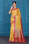 Shop yellow Kora Banarasi sari online in USA with pink border. Look your best on festive occasions in latest designer sarees, pure silk saris, Kanchipuram silk sarees, handwoven sarees, tussar silk sarees, embroidered saris from Pure Elegance Indian clothing store in USA.-full view