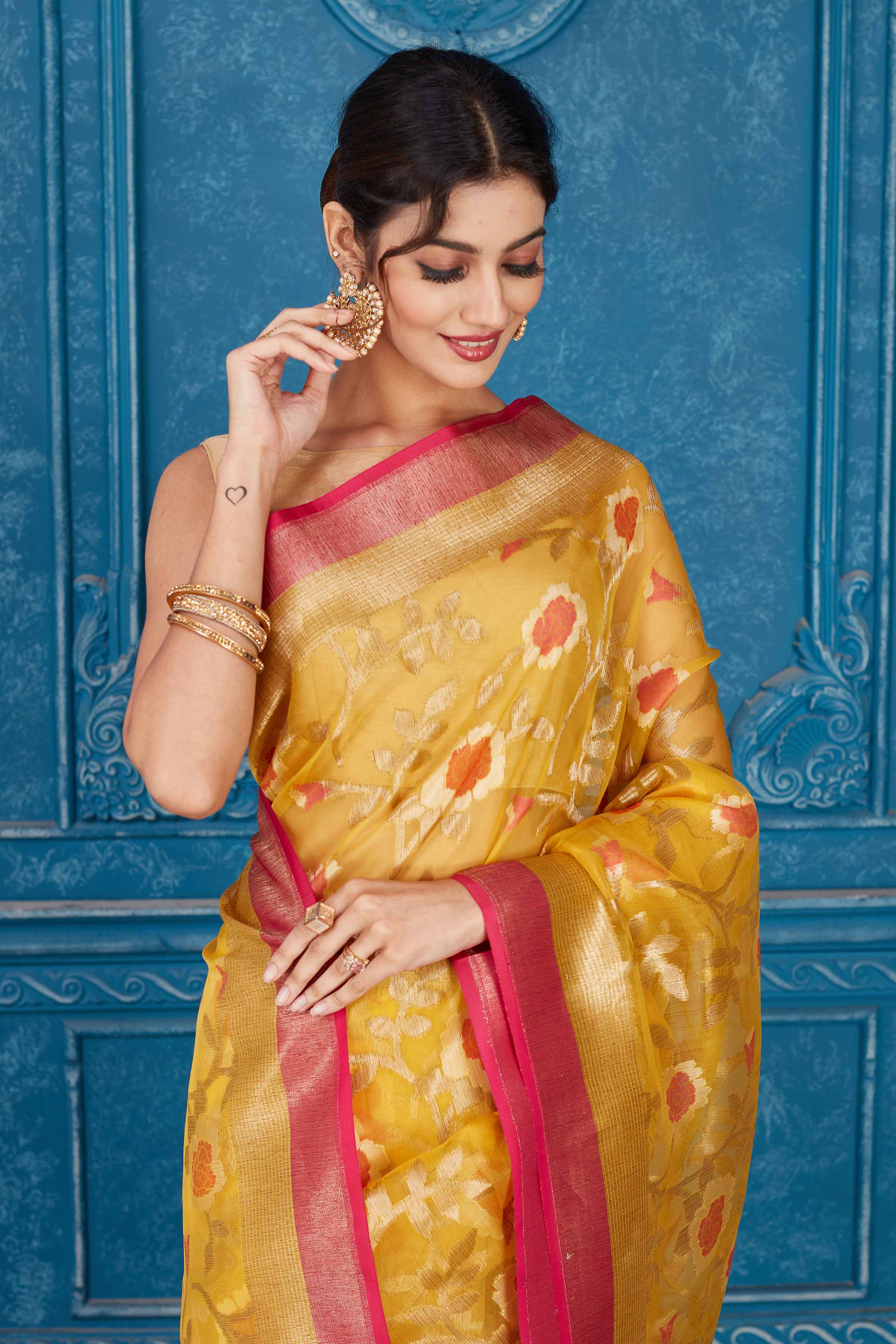 Shop yellow Kora Banarasi sari online in USA with pink border. Look your best on festive occasions in latest designer sarees, pure silk saris, Kanchipuram silk sarees, handwoven sarees, tussar silk sarees, embroidered saris from Pure Elegance Indian clothing store in USA.-closeup
