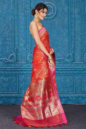 Shop red Kora Banarasi sari online in USA with pink border. Look your best on festive occasions in latest designer sarees, pure silk saris, Kanchipuram silk sarees, handwoven sarees, tussar silk sarees, embroidered saris from Pure Elegance Indian clothing store in USA.-side