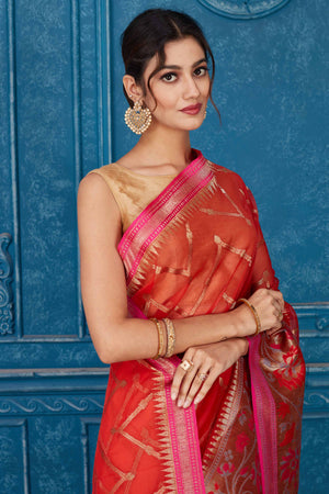 Shop red Kora Banarasi sari online in USA with pink border. Look your best on festive occasions in latest designer sarees, pure silk saris, Kanchipuram silk sarees, handwoven sarees, tussar silk sarees, embroidered saris from Pure Elegance Indian clothing store in USA.-closeup
