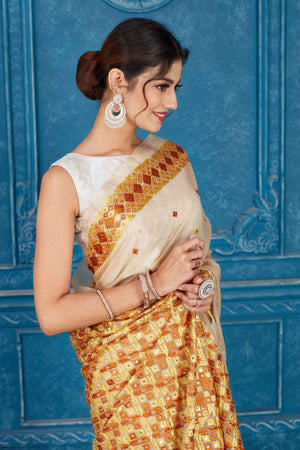 Shop cream Kota saree online in USA with Phulkari embroidery. Look your best on festive occasions in latest designer sarees, pure silk saris, Kanchipuram silk sarees, handwoven sarees, tussar silk sarees, embroidered saris from Pure Elegance Indian clothing store in USA.-closeup