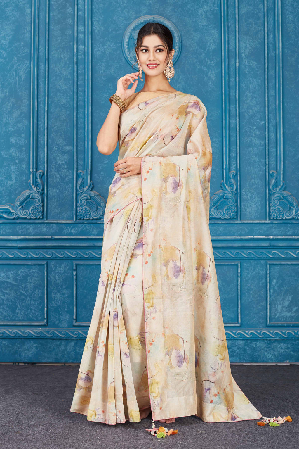 Shop elegant cream linen sari online in USA. Look your best on festive occasions in latest designer sarees, pure silk saris, Kanchipuram silk sarees, handwoven sarees, tussar silk sarees, embroidered saris from Pure Elegance Indian clothing store in USA.-front