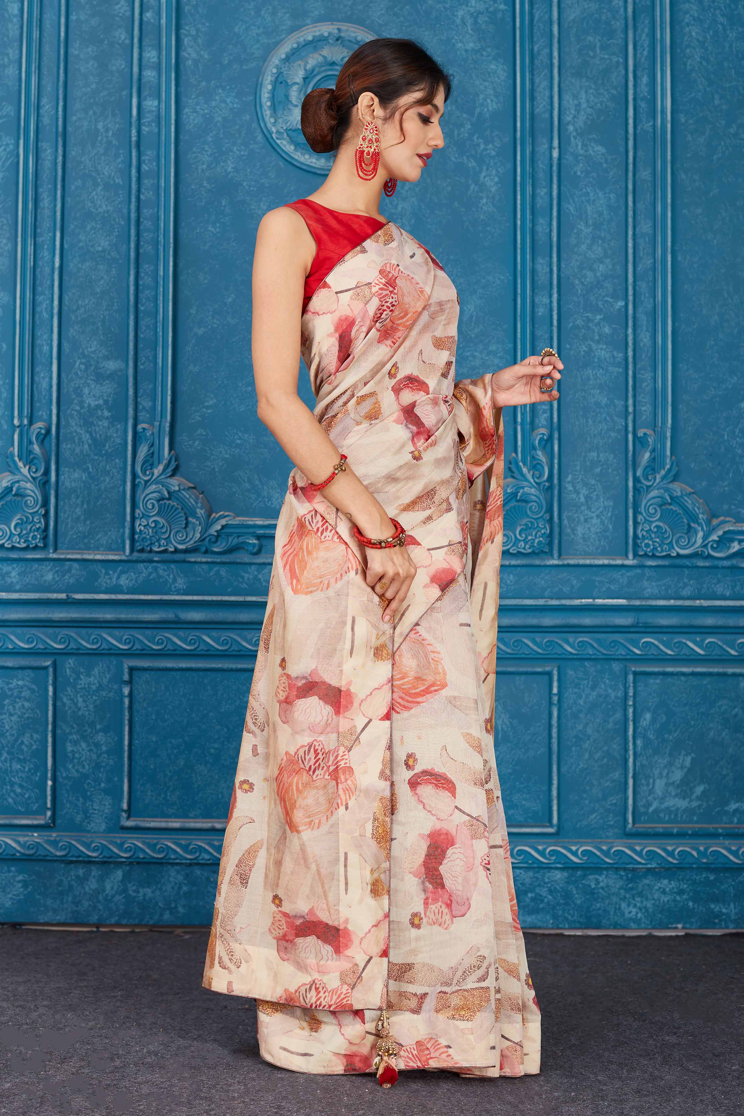 Shop stunning cream and red floral print linen sari online in USA. Look your best on festive occasions in latest designer sarees, pure silk saris, Kanchipuram silk sarees, handwoven sarees, tussar silk sarees, embroidered saris from Pure Elegance Indian clothing store in USA.-side