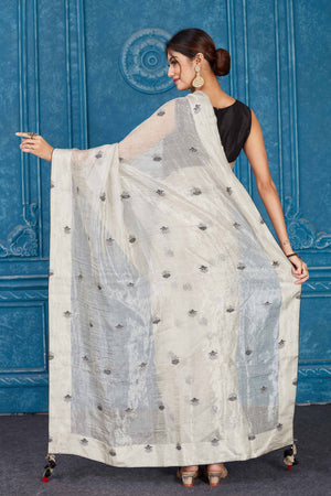 Shop silver tissue silk sari online in USA with black floral buta. Look your best on festive occasions in latest designer sarees, pure silk saris, Kanchipuram silk sarees, handwoven sarees, tussar silk sarees, embroidered saris from Pure Elegance Indian clothing store in USA.-back