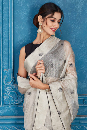 Shop silver tissue silk sari online in USA with black floral buta. Look your best on festive occasions in latest designer sarees, pure silk saris, Kanchipuram silk sarees, handwoven sarees, tussar silk sarees, embroidered saris from Pure Elegance Indian clothing store in USA.-closeup