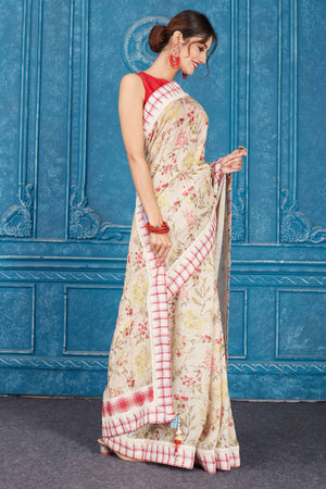 Shop cream printed linen saree online in USA with check border Look your best on festive occasions in latest designer sarees, pure silk saris, Kanchipuram silk sarees, handwoven sarees, tussar silk sarees, embroidered saris from Pure Elegance Indian clothing store in USA.-side
