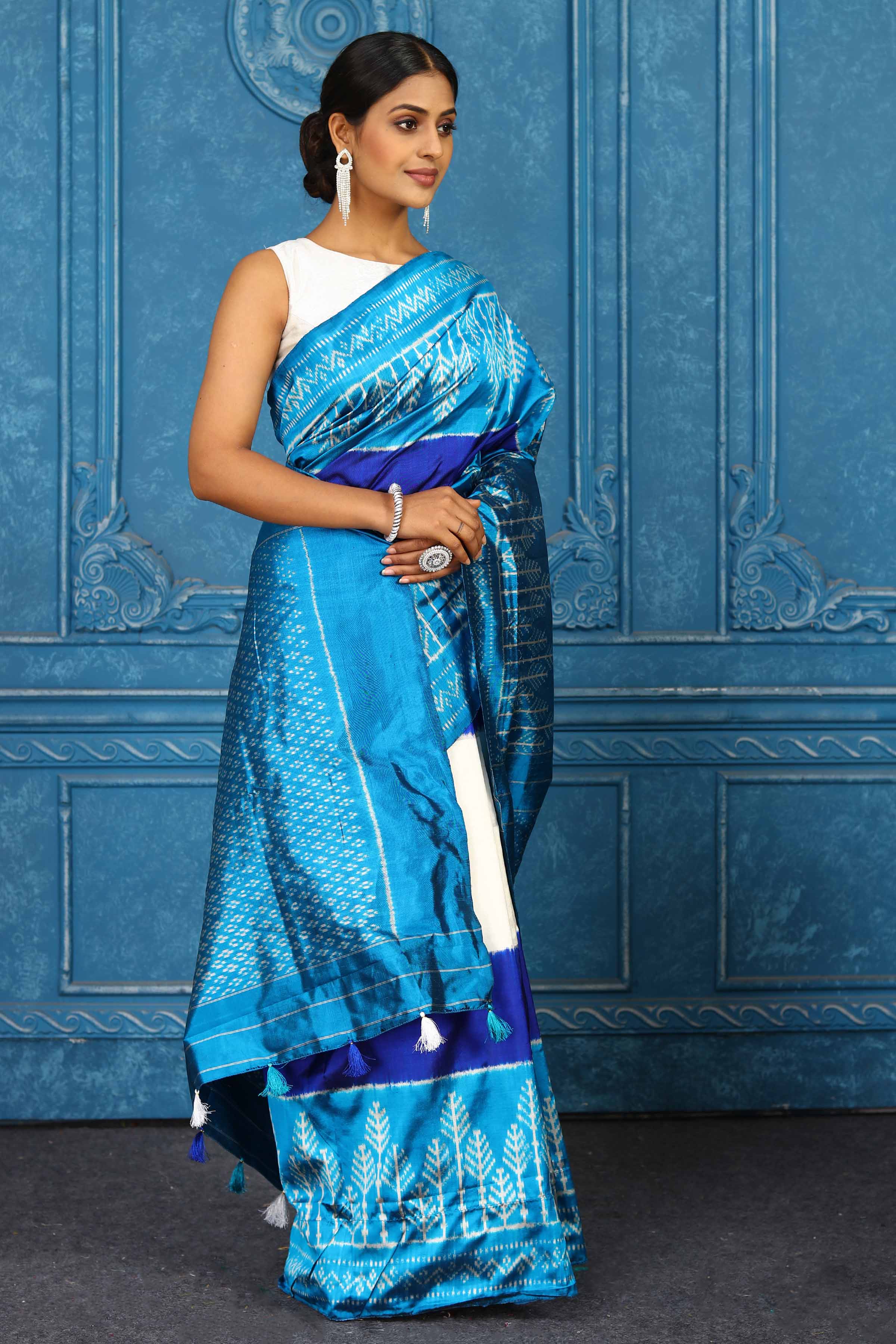 Shop cream and blue pochampally silk ikkat sari online in USA. Look your best on festive occasions in latest designer sarees, pure silk sarees, Kanchipuram sarees, handwoven sarees, tussar silk sarees, embroidered sarees from Pure Elegance Indian clothing store in USA.-side