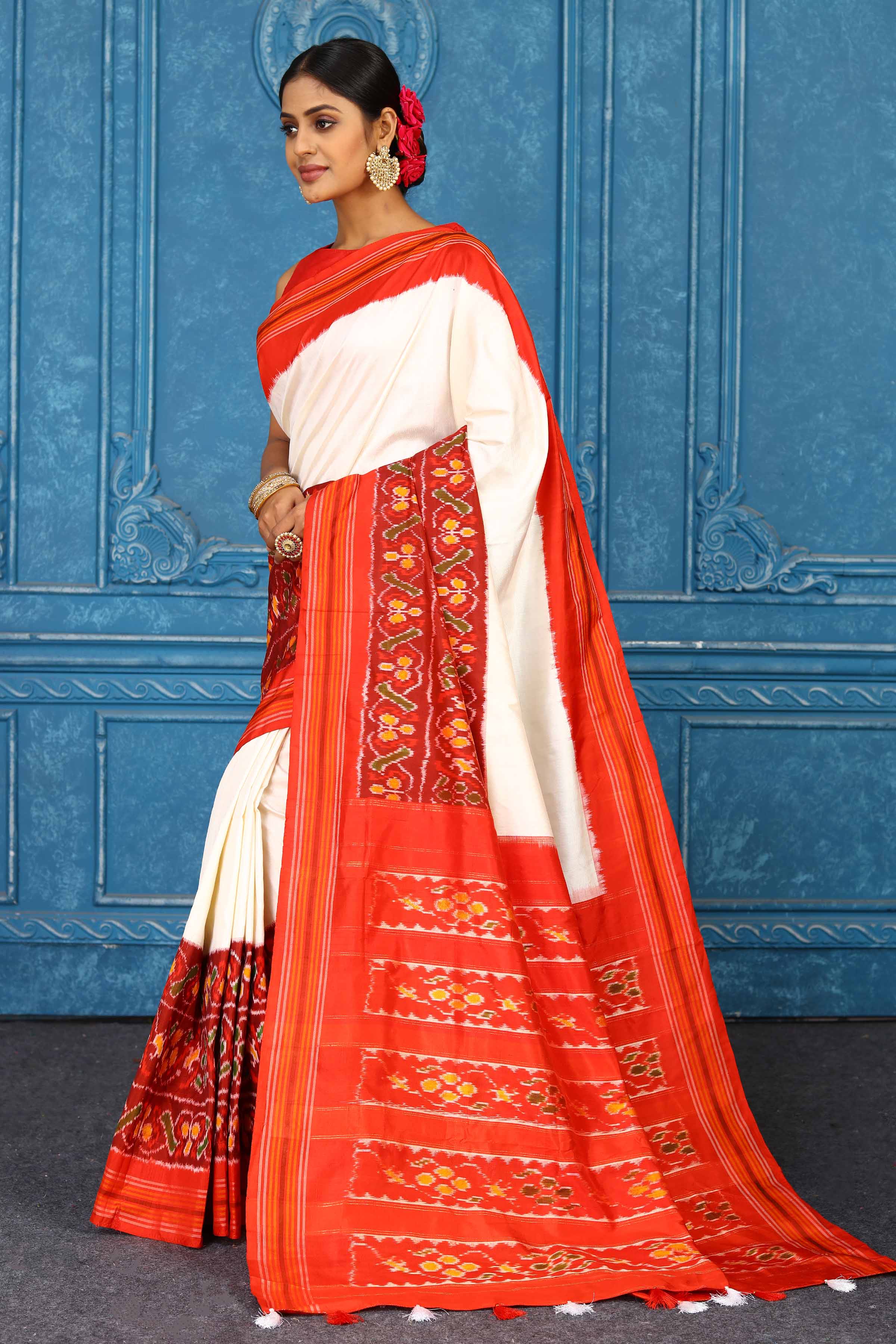 Shop beautiful cream and red pochampally silk ikkat saree online in USA. Look your best on festive occasions in latest designer sarees, pure silk sarees, Kanchipuram sarees, handwoven sarees, tussar silk sarees, embroidered sarees from Pure Elegance Indian clothing store in USA.-side