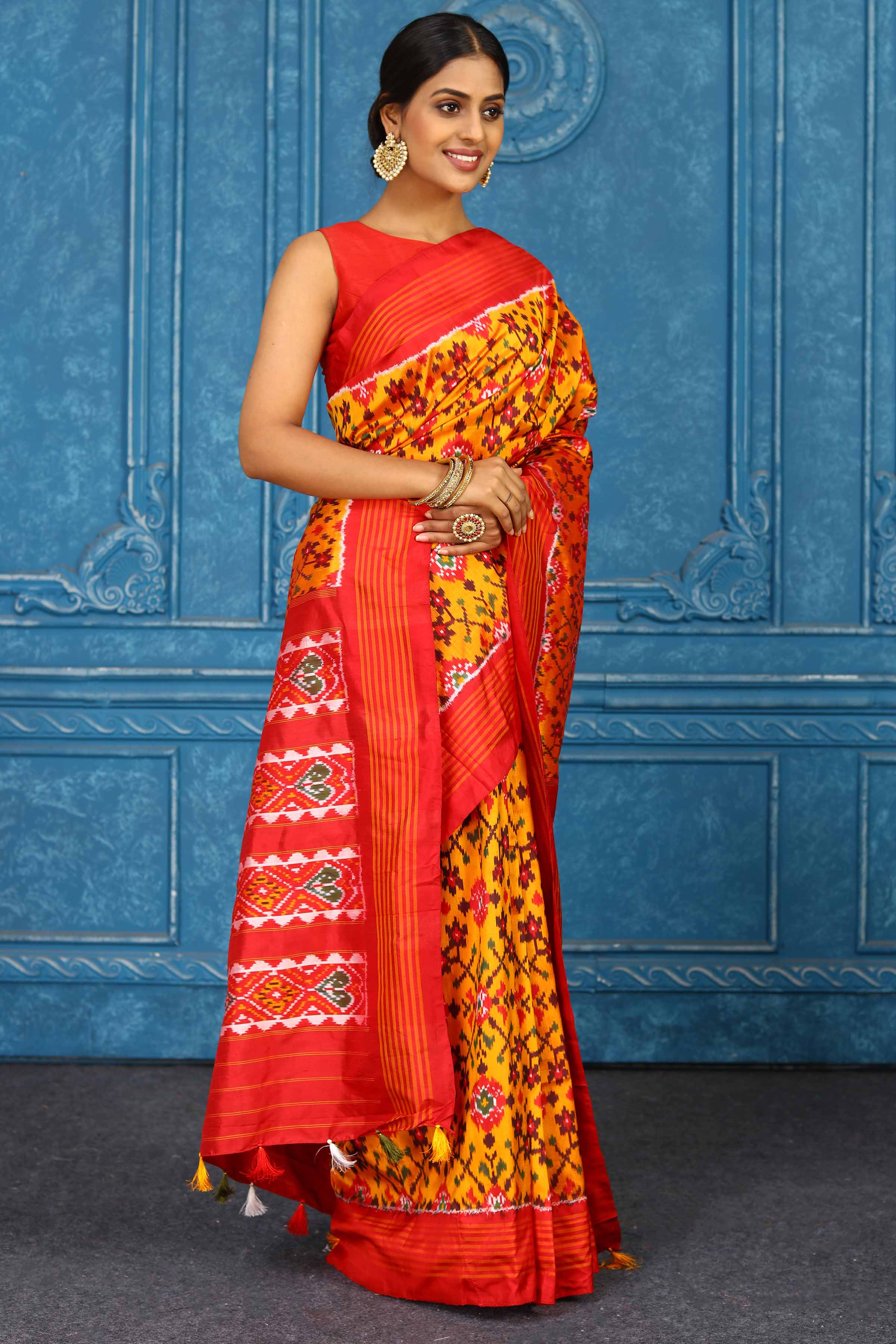 Shop beautiful mustard pochampally silk ikkat saree online in USA with orange striped border. Look your best on festive occasions in latest designer sarees, pure silk sarees, Kanchipuram sarees, handwoven sarees, tussar silk sarees, embroidered sarees from Pure Elegance Indian clothing store in USA.-side