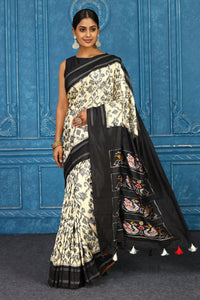 Buy off-white pochampally silk ikkat saree online in USA with black border. Look your best on festive occasions in latest designer sarees, pure silk sarees, Kanchipuram sarees, handwoven sarees, tussar silk sarees, embroidered sarees from Pure Elegance Indian clothing store in USA.-full view