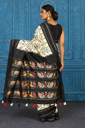 Buy off-white pochampally silk ikkat saree online in USA with black border. Look your best on festive occasions in latest designer sarees, pure silk sarees, Kanchipuram sarees, handwoven sarees, tussar silk sarees, embroidered sarees from Pure Elegance Indian clothing store in USA.-back