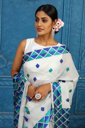 Buy elegant white phulkari embroidery sari online in USA. Look your best on festive occasions in latest designer sarees, pure silk sarees, Kanchipuram sarees, handwoven sarees, tussar silk sarees, embroidered sarees from Pure Elegance Indian clothing store in USA.-closeup