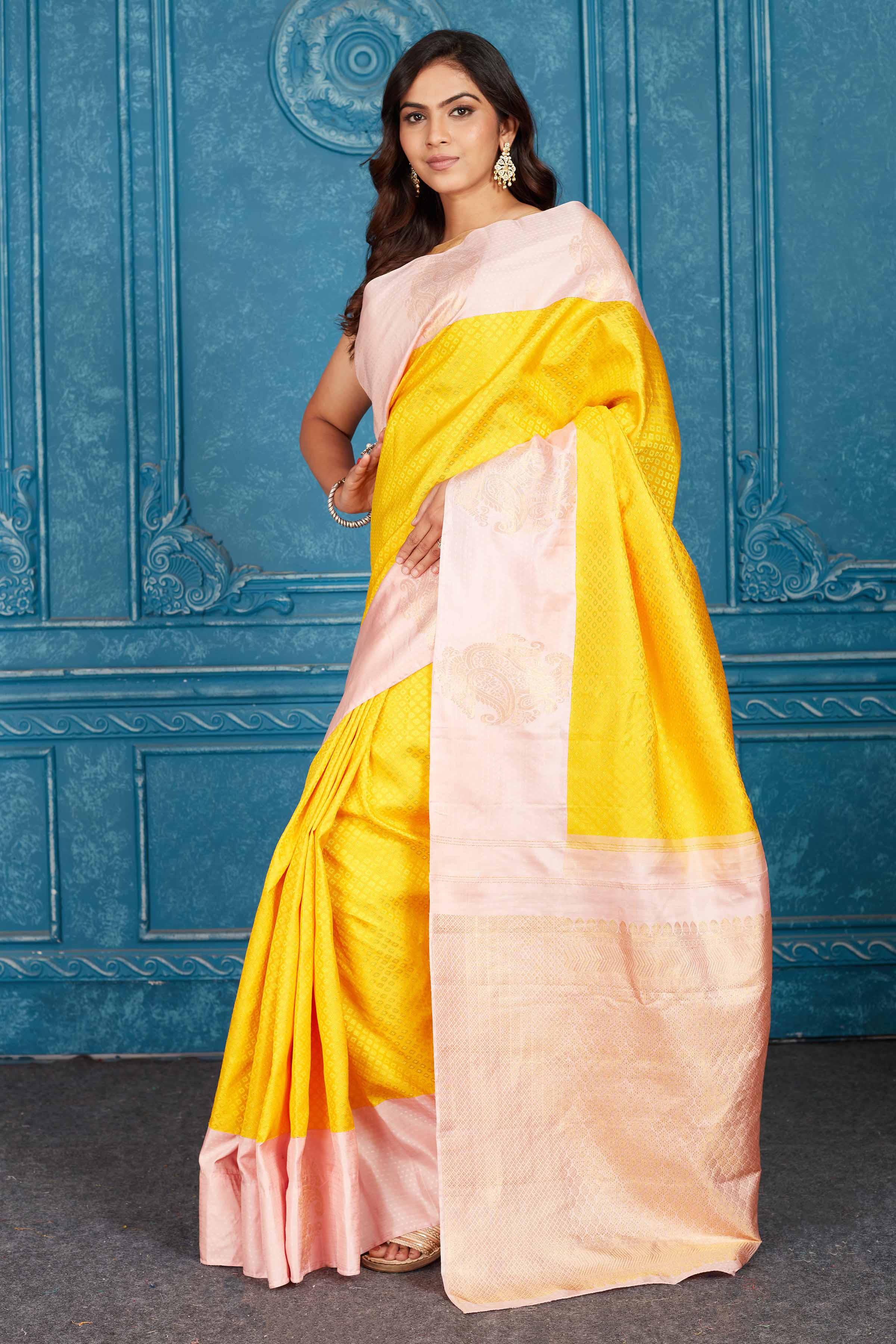 Shop yellow and powder pink Kanchipuram silk saree online in USA. Level up your ethnic style in latest designer saris, pure silk saris, Kanchipuram silk saris, handwoven sarees, tussar silk sarees, embroidered saris from Pure Elegance Indian clothing store in USA.-saree