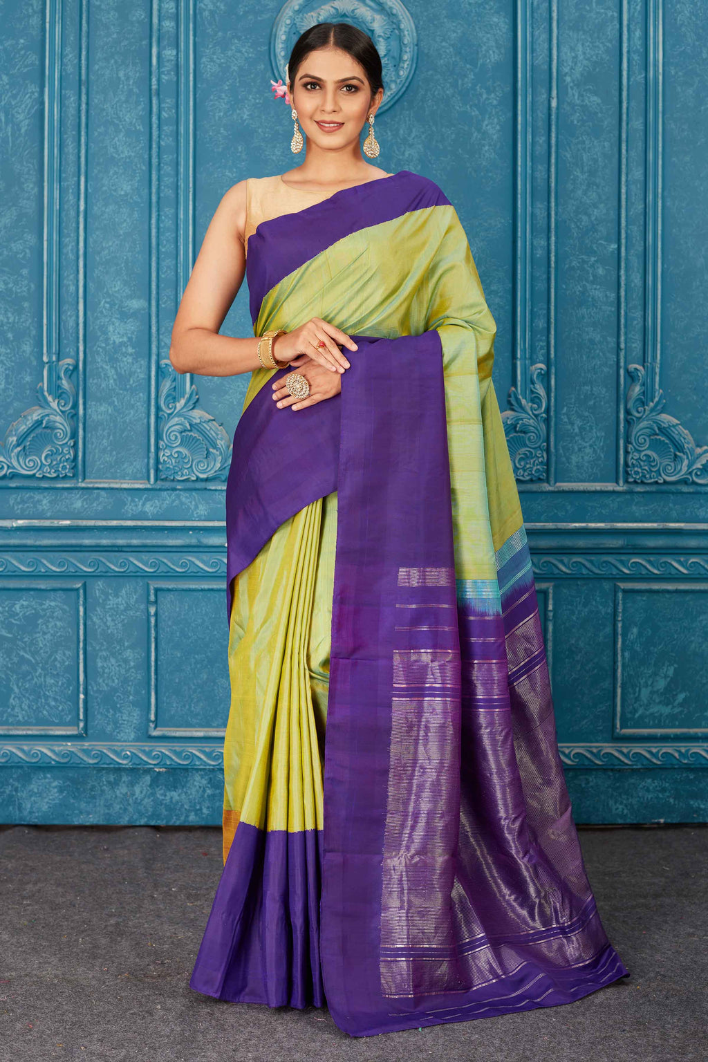 Buy pista green Kanchipuram silk sari online in USA with purple border. Radiate glam at parties in dazzling designer sarees, party sarees, embroidered sarees, sequin work sarees, Bollywood sarees, handloom sarees from Pure Elegance Indian saree store in USA.-full view