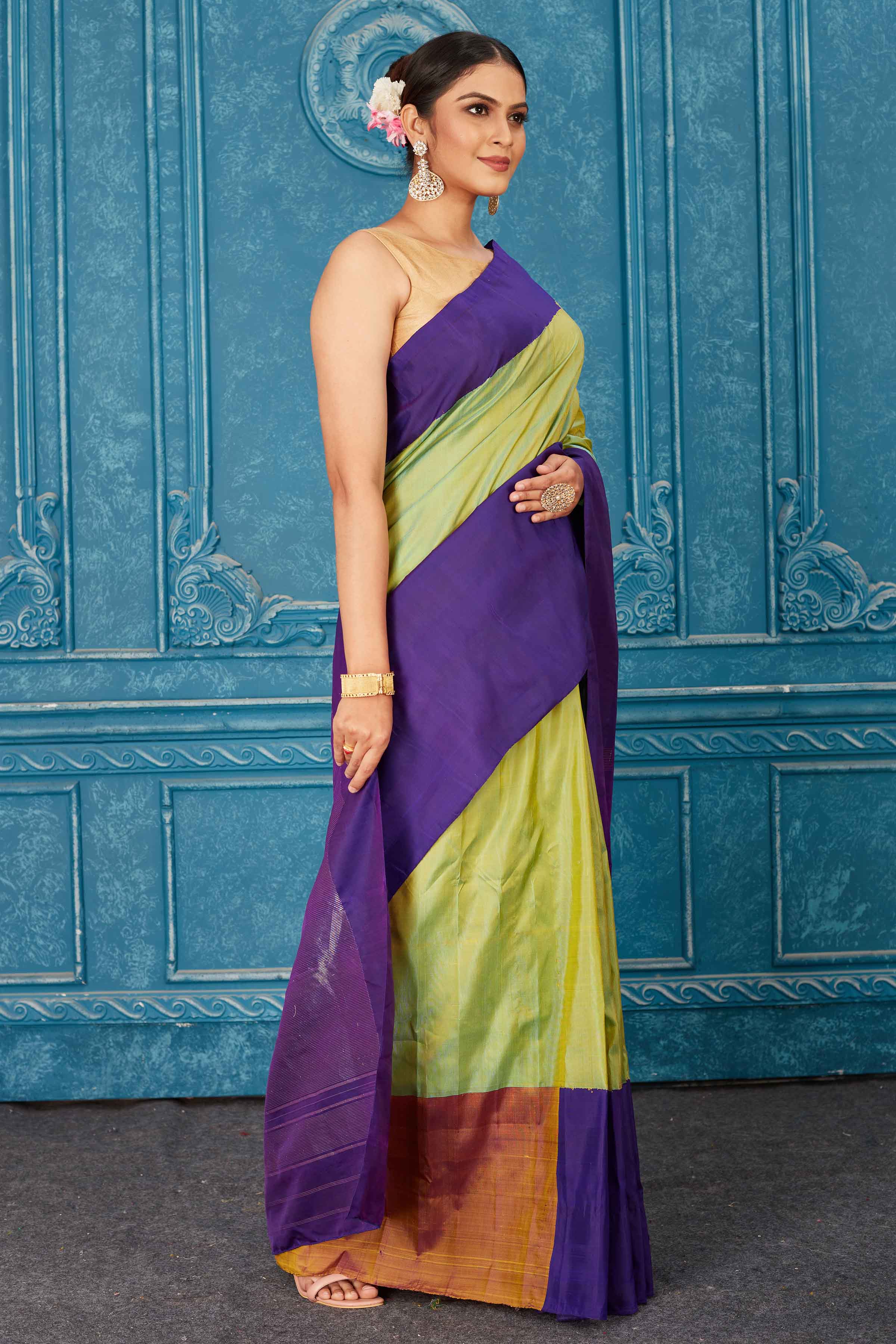 Buy pista green Kanchipuram silk sari online in USA with purple border. Radiate glam at parties in dazzling designer sarees, party sarees, embroidered sarees, sequin work sarees, Bollywood sarees, handloom sarees from Pure Elegance Indian saree store in USA.-side