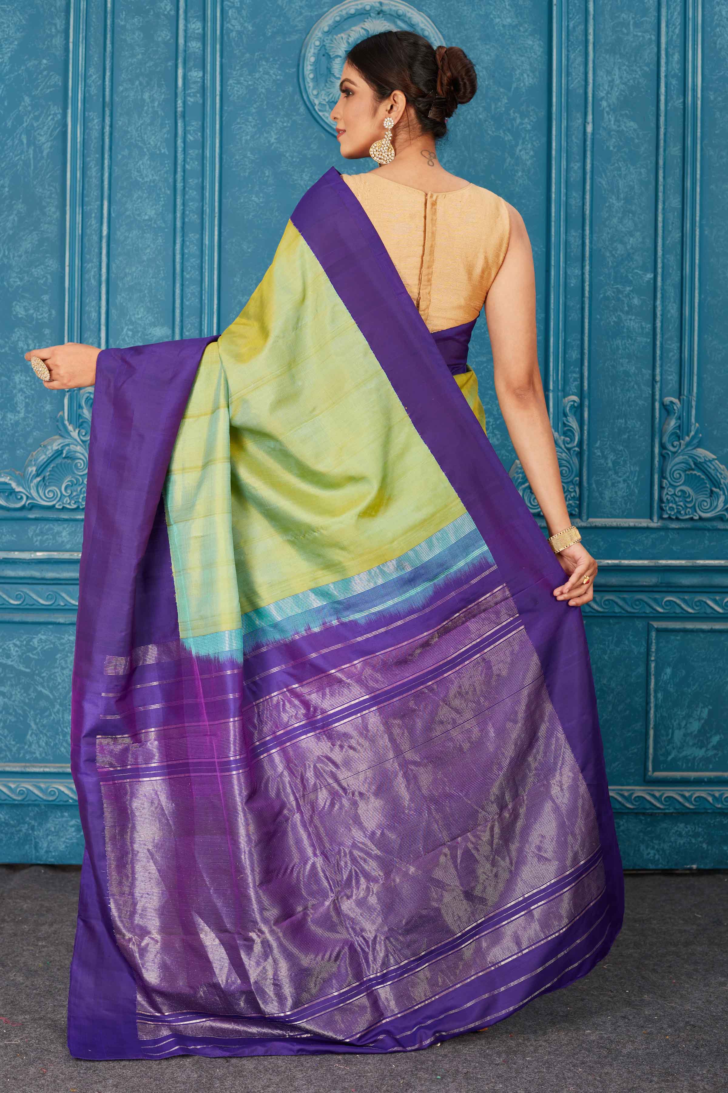 Buy pista green Kanchipuram silk sari online in USA with purple border. Radiate glam at parties in dazzling designer sarees, party sarees, embroidered sarees, sequin work sarees, Bollywood sarees, handloom sarees from Pure Elegance Indian saree store in USA.-back