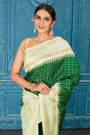Buy stunning green Kanchipuram silk saree online in USA with mint green border. Radiate glam at parties in dazzling designer sarees, party sarees, embroidered sarees, sequin work sarees, Bollywood sarees, handloom sarees from Pure Elegance Indian saree store in USA.-closeup