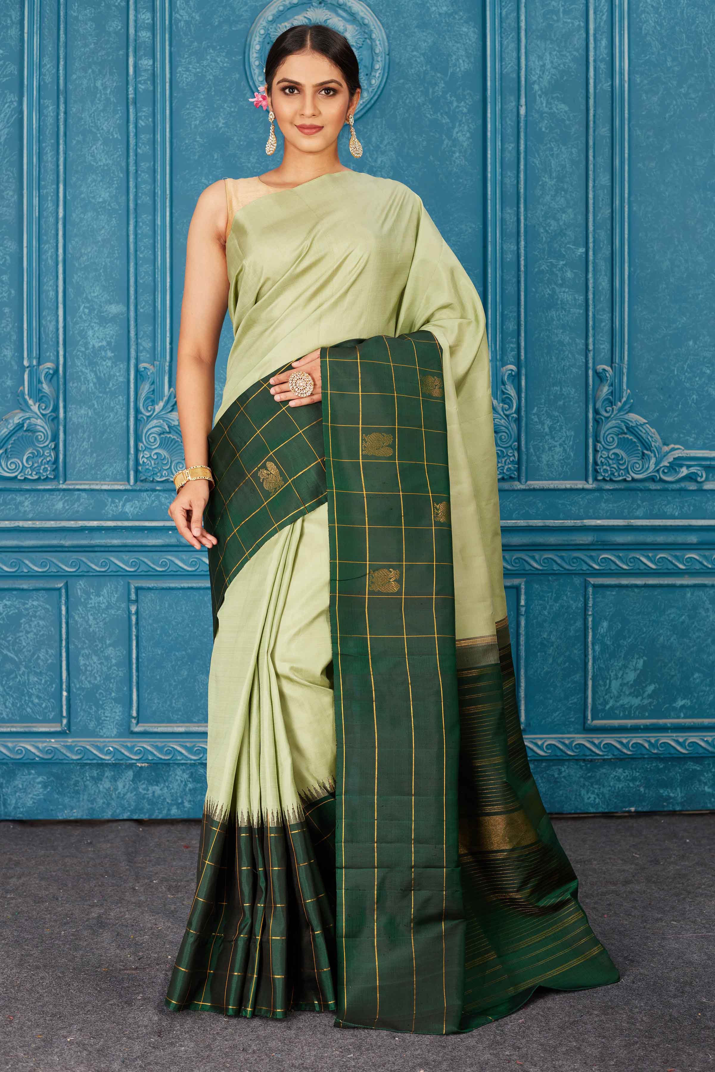 Buy beautiful pista green Gadhwal silk saree online in USA with dark green check border. Radiate glam at parties in dazzling designer sarees, party sarees, embroidered sarees, sequin work sarees, Bollywood sarees, handloom sarees from Pure Elegance Indian saree store in USA.-full view