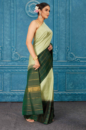 Buy beautiful pista green Gadhwal silk saree online in USA with dark green check border. Radiate glam at parties in dazzling designer sarees, party sarees, embroidered sarees, sequin work sarees, Bollywood sarees, handloom sarees from Pure Elegance Indian saree store in USA.-side