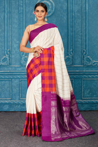 Buy beautiful white Gadhwal silk saree online in USA with orange purple check border. Radiate glam at parties in dazzling designer sarees, party sarees, embroidered sarees, sequin work sarees, Bollywood sarees, handloom sarees from Pure Elegance Indian saree store in USA.-full view