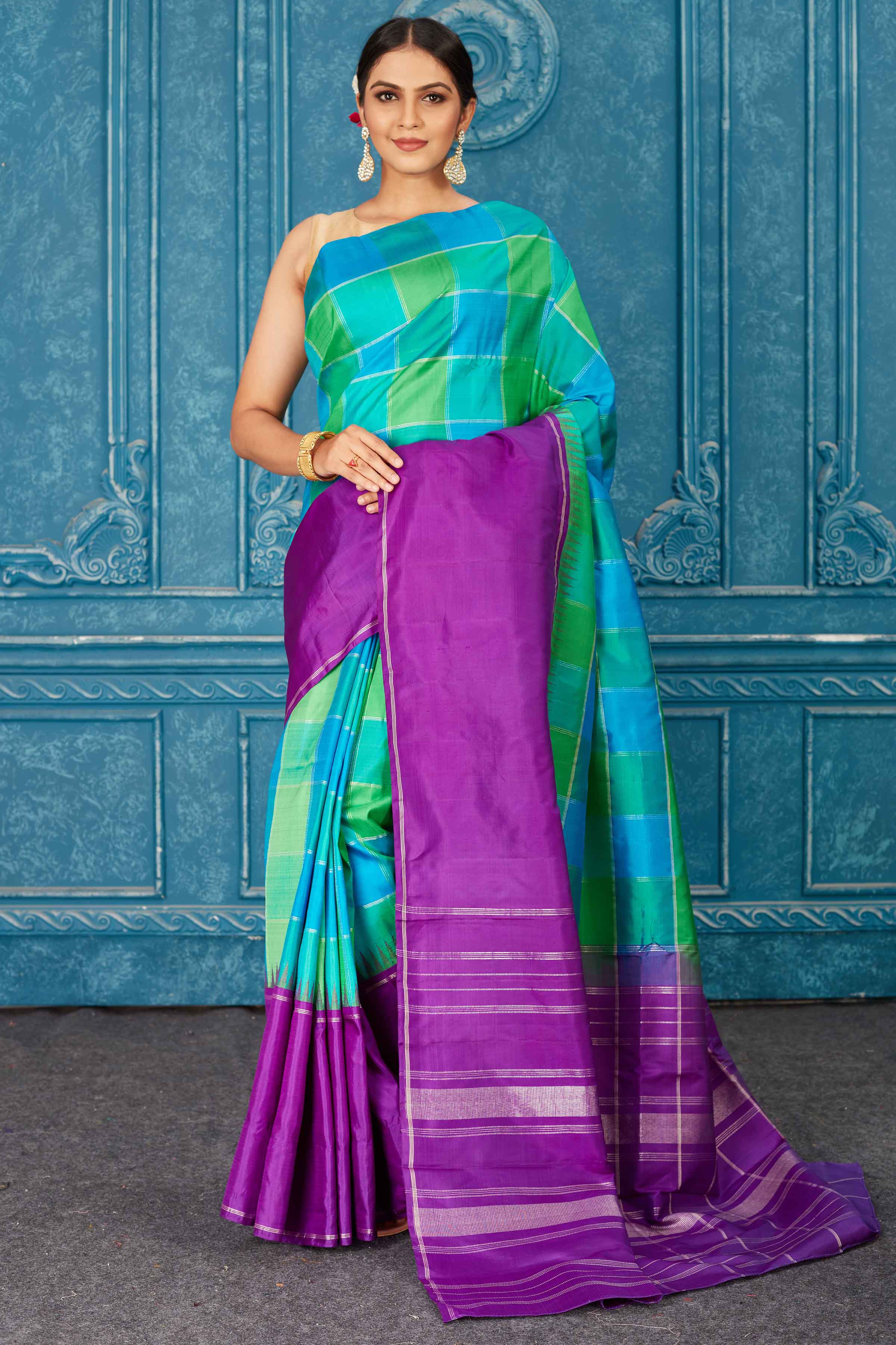 Shop beautiful green and blue check Kanjeevaram silk sari online in USA with purple border. Radiate glam at parties in dazzling designer sarees, party sarees, embroidered sarees, sequin work sarees, Bollywood sarees, handloom sarees from Pure Elegance Indian saree store in USA.-full view
