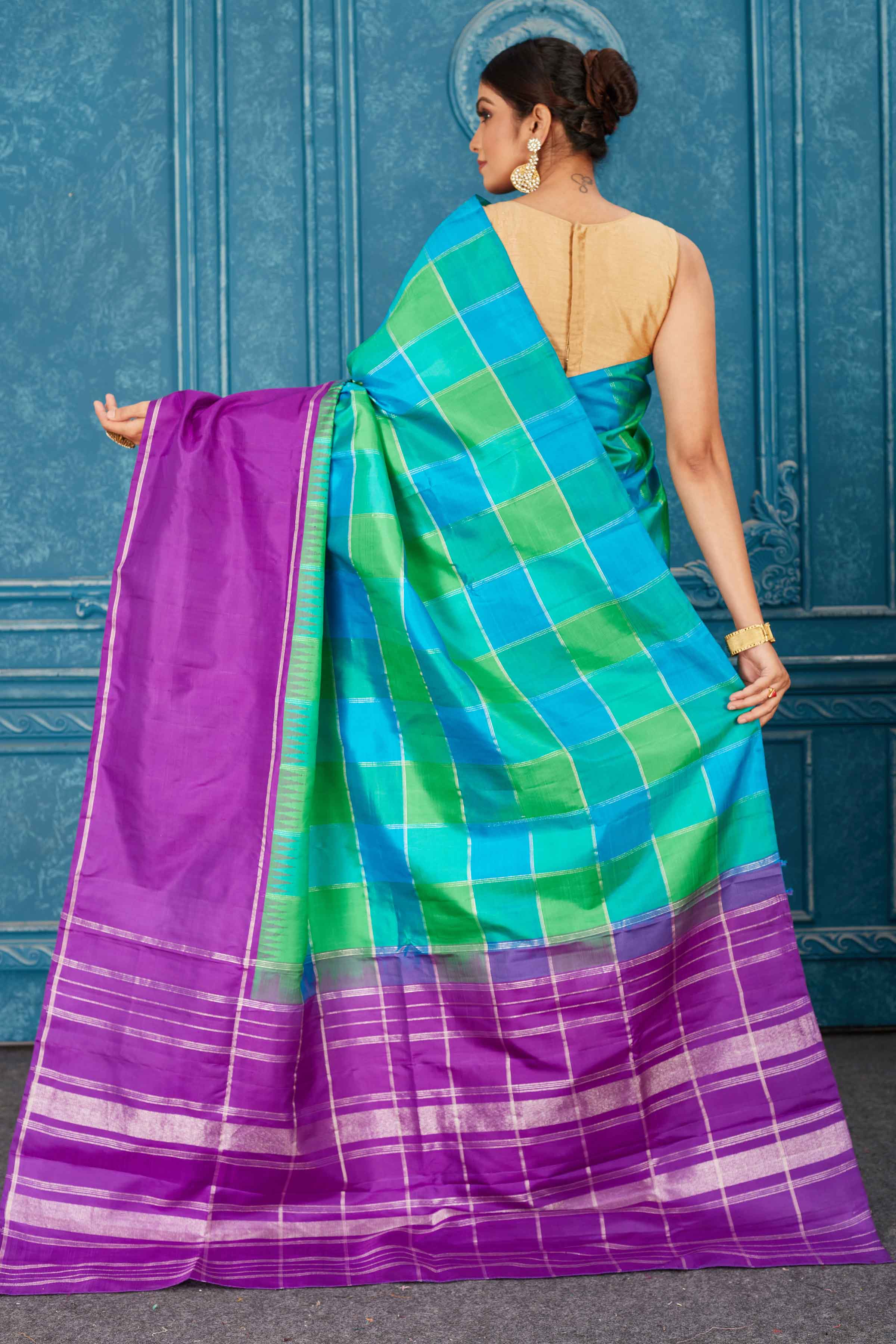Shop beautiful green and blue check Kanjeevaram silk sari online in USA with purple border. Radiate glam at parties in dazzling designer sarees, party sarees, embroidered sarees, sequin work sarees, Bollywood sarees, handloom sarees from Pure Elegance Indian saree store in USA.-back