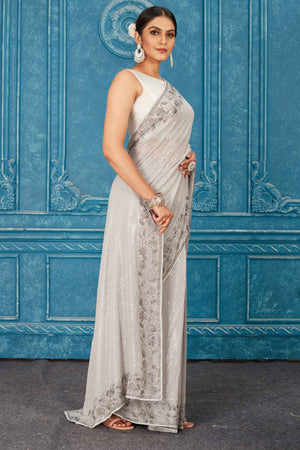 Shop beautiful light grey sequin saree online in USA with stone work. Radiate glam at parties in dazzling designer sarees, party sarees, embroidered sarees, sequin work sarees, Bollywood sarees, handloom sarees from Pure Elegance Indian saree store in USA.-side