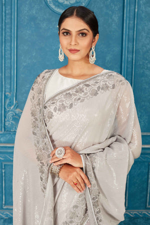 Shop beautiful light grey sequin saree online in USA with stone work. Radiate glam at parties in dazzling designer sarees, party sarees, embroidered sarees, sequin work sarees, Bollywood sarees, handloom sarees from Pure Elegance Indian saree store in USA.-closeup
