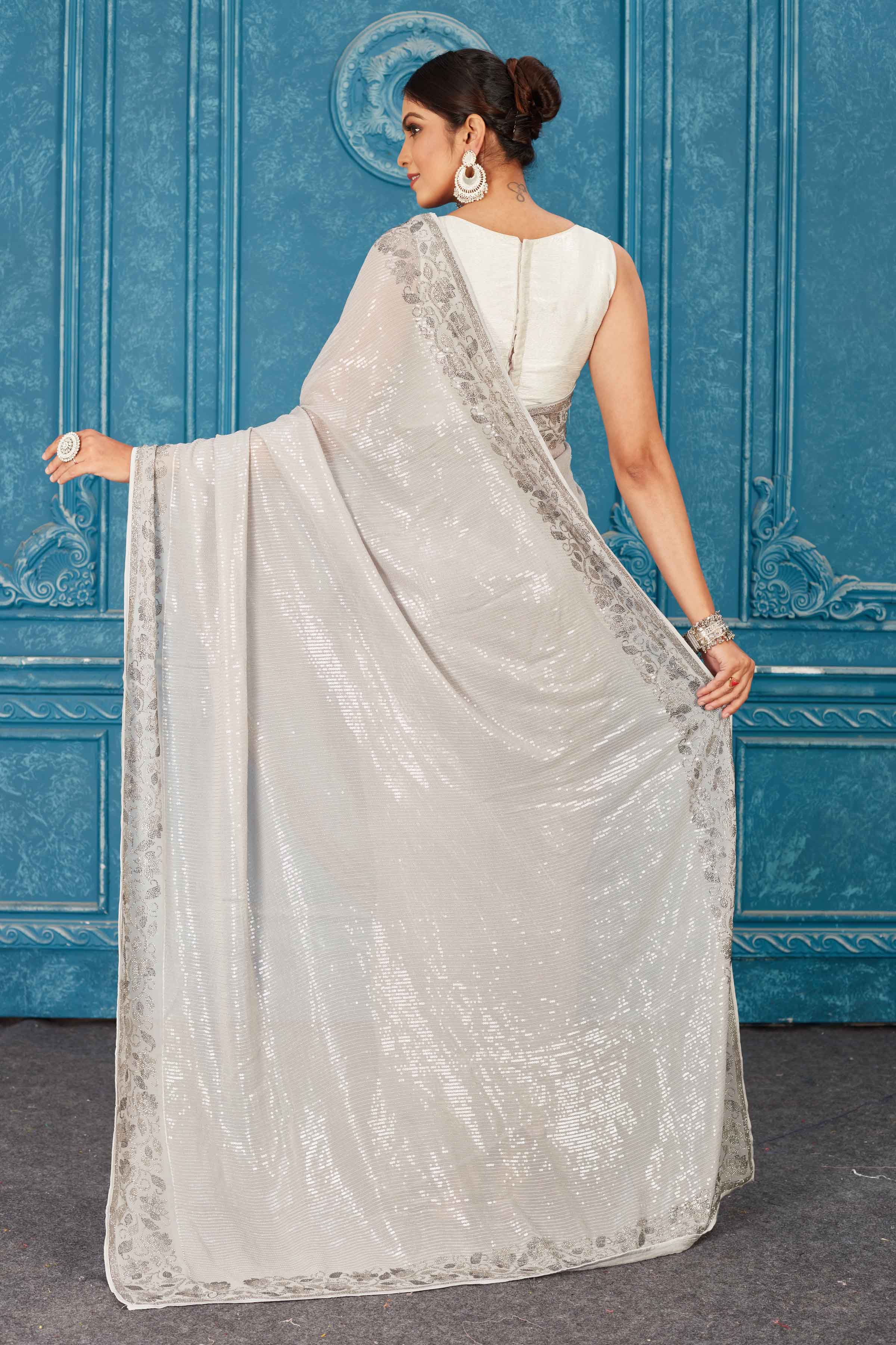 Shop beautiful light grey sequin saree online in USA with stone work. Radiate glam at parties in dazzling designer sarees, party sarees, embroidered sarees, sequin work sarees, Bollywood sarees, handloom sarees from Pure Elegance Indian saree store in USA.-back