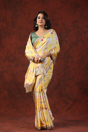 Shop yellow floral print crepe sari online in USA with embroidered border. Make a fashion statement on festive occasions and weddings with designer suits, Indian dresses, Anarkali suits, palazzo suits, designer sarees, sharara suits, Bollywood saris from Pure Elegance Indian fashion store in USA.-front
