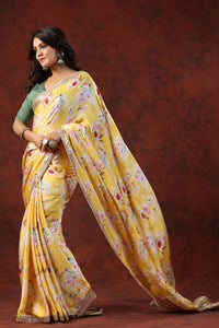 Shop yellow floral print crepe sari online in USA with embroidered border. Make a fashion statement on festive occasions and weddings with designer suits, Indian dresses, Anarkali suits, palazzo suits, designer sarees, sharara suits, Bollywood saris from Pure Elegance Indian fashion store in USA.-full view