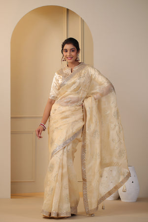 Shop beautiful cream embroidered organza sari online in USA with embroidered blouse. Make a fashion statement on festive occasions and weddings with designer suits, Indian dresses, Anarkali suits, palazzo suits, designer sarees, sharara suits, Bollywood saris from Pure Elegance Indian fashion store in USA.-full view