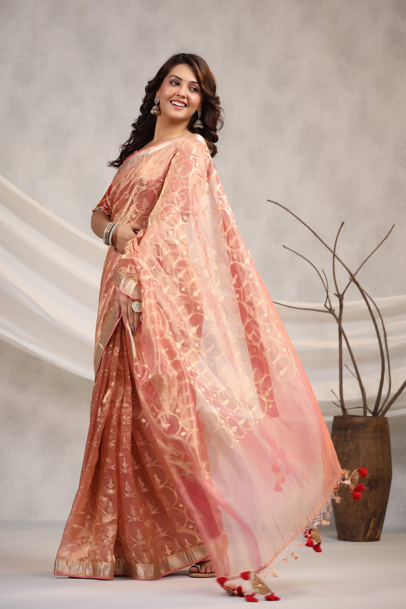 Shop light pink silk organza sari online in USA with red saree blouse. Make a fashion statement on festive occasions and weddings with designer suits, Indian dresses, Anarkali suits, palazzo suits, designer sarees, sharara suits, Bollywood saris from Pure Elegance Indian fashion store in USA.-pallu