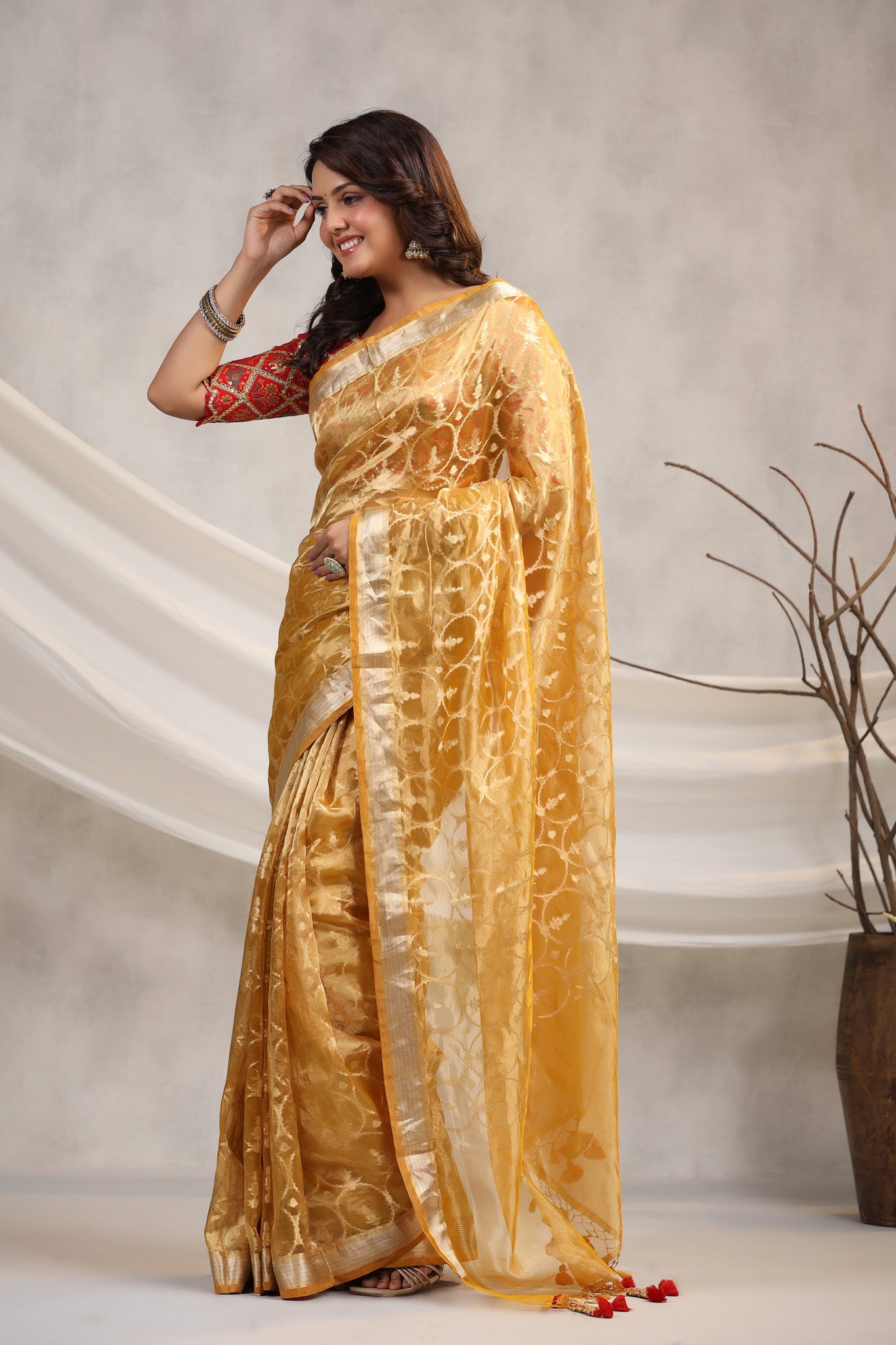 Buy yellow silk organza sari online in USA with red saree blouse. Make a fashion statement on festive occasions and weddings with designer suits, Indian dresses, Anarkali suits, palazzo suits, designer sarees, sharara suits, Bollywood saris from Pure Elegance Indian fashion store in USA.-pallu