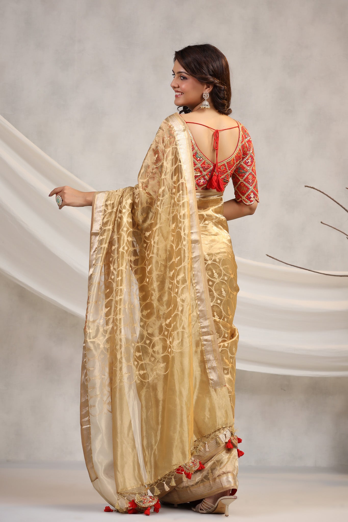 Shop golden silk organza sari online in USA with red saree blouse. Make a fashion statement on festive occasions and weddings with designer suits, Indian dresses, Anarkali suits, palazzo suits, designer sarees, sharara suits, Bollywood saris from Pure Elegance Indian fashion store in USA.-back