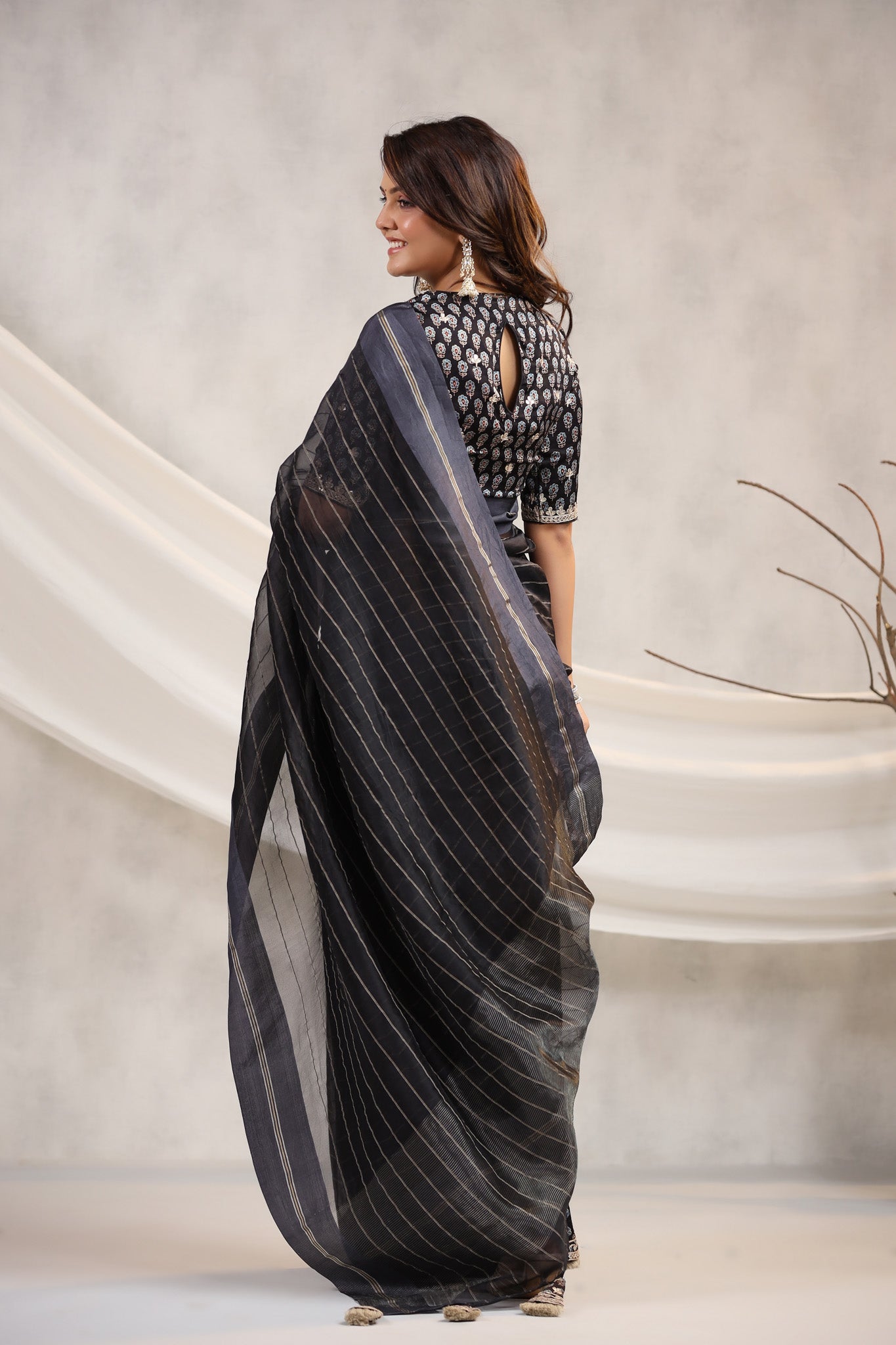 Shop black tissue organza sari online in USA with printed embroidered blouse. Make a fashion statement on festive occasions and weddings with designer suits, Indian dresses, Anarkali suits, palazzo suits, designer sarees, sharara suits, Bollywood saris from Pure Elegance Indian fashion store in USA.-back
