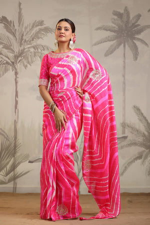 Buy stunning pink leheriya embroidered tussar silk sari online in USA with pink designer blouse. Make a fashion statement on festive occasions and weddings with designer suits, Indian dresses, Anarkali suits, palazzo suits, designer sarees, sharara suits, Bollywood saris from Pure Elegance Indian fashion store in USA.-front