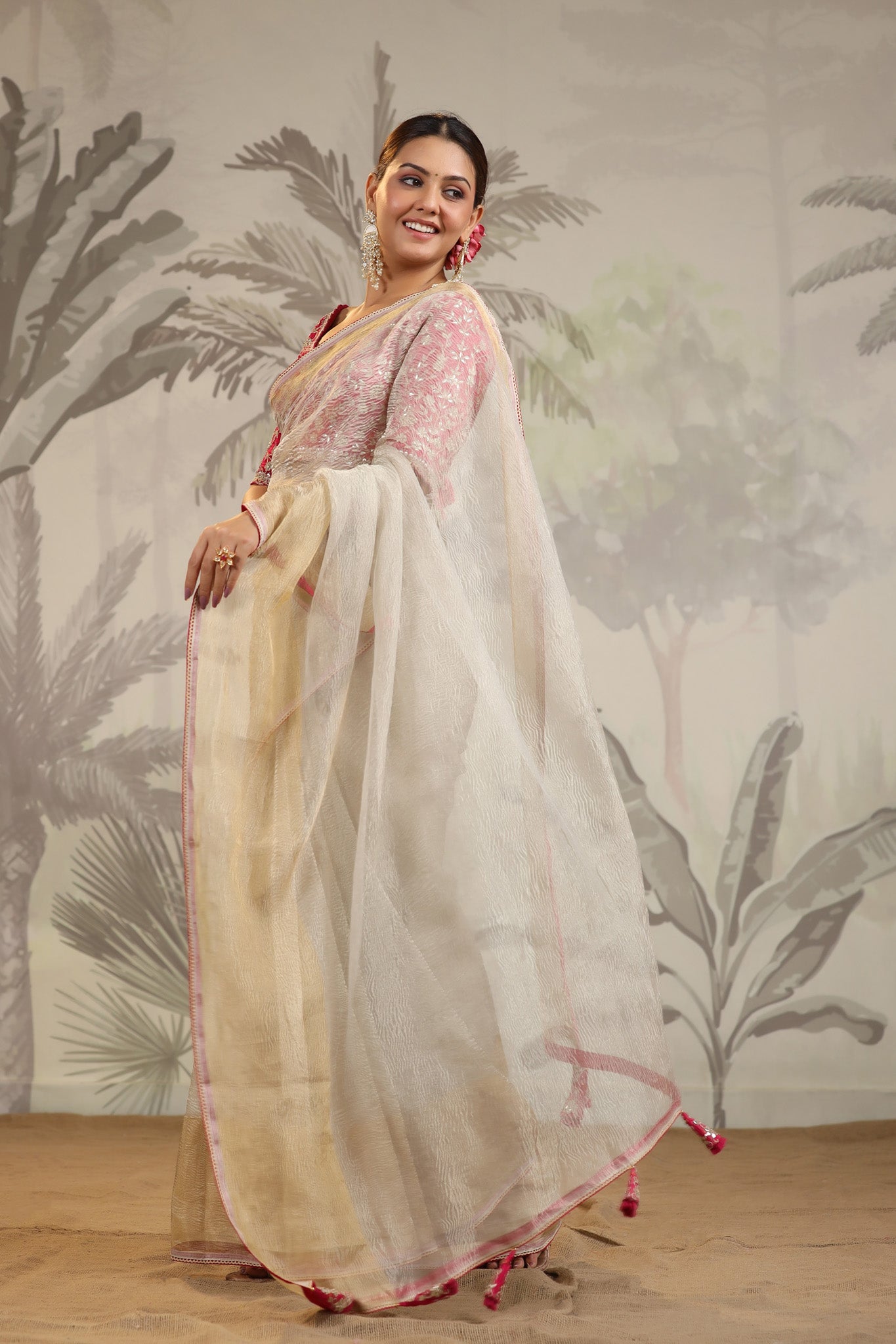 Buy beautiful cream tissue organza sari online in USA with pink embroidered designer blouse. Make a fashion statement on festive occasions and weddings with designer suits, Indian dresses, Anarkali suits, palazzo suits, designer sarees, sharara suits, Bollywood saris from Pure Elegance Indian fashion store in USA.-pallu