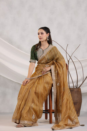 Shop beautiful mustard striped organza saree online in USA with green embroidered blouse. Make a fashion statement on festive occasions and weddings with designer suits, Indian dresses, Anarkali suits, palazzo suits, designer sarees, sharara suits, Bollywood saris from Pure Elegance Indian fashion store in USA.-saree