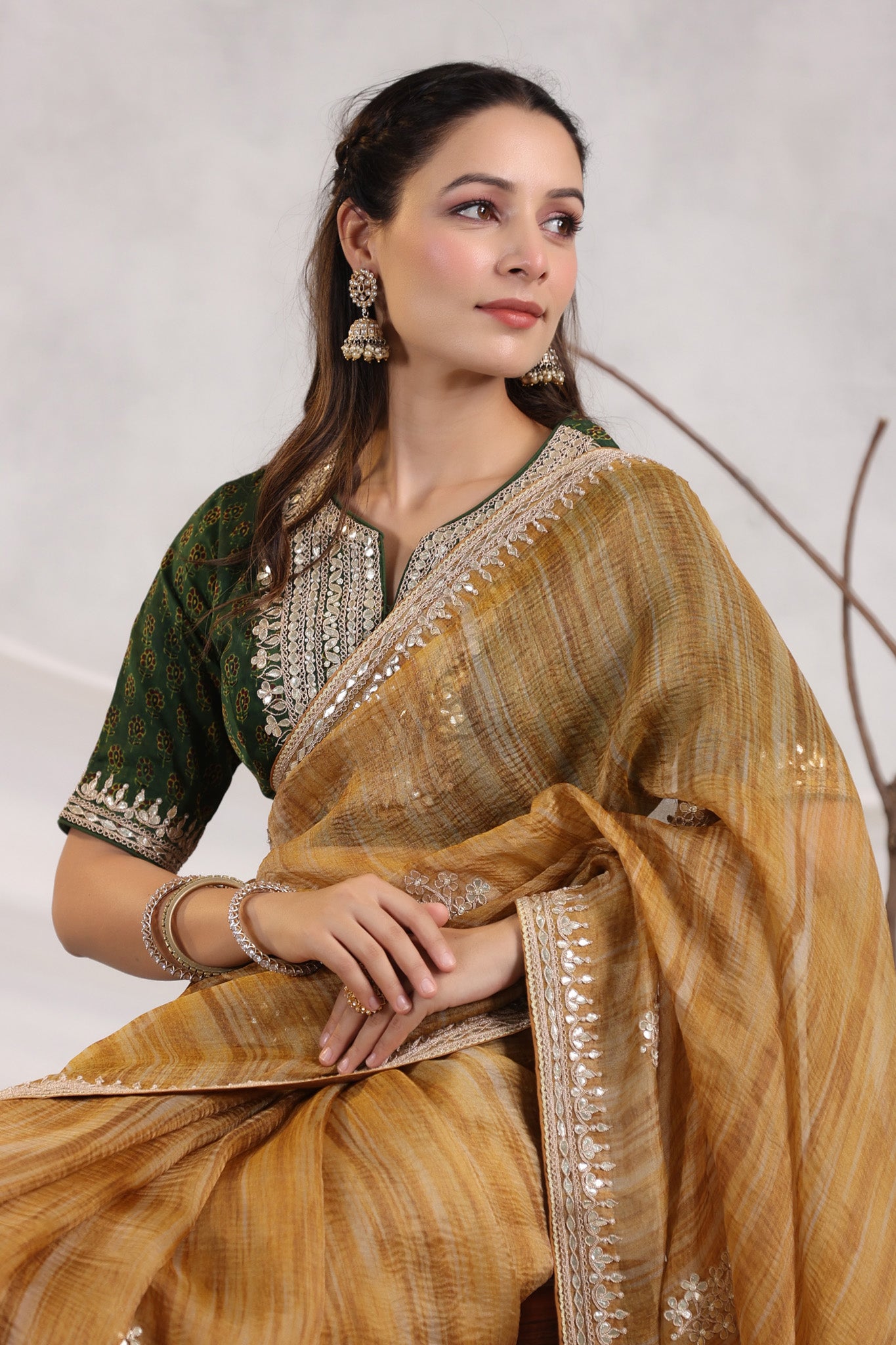 Shop beautiful mustard striped organza saree online in USA with green embroidered blouse. Make a fashion statement on festive occasions and weddings with designer suits, Indian dresses, Anarkali suits, palazzo suits, designer sarees, sharara suits, Bollywood saris from Pure Elegance Indian fashion store in USA.-closeup