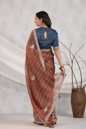 Buy brown striped organza saree online in USA with blue embroidered blouse. Make a fashion statement on festive occasions and weddings with designer suits, Indian dresses, Anarkali suits, palazzo suits, designer sarees, sharara suits, Bollywood saris from Pure Elegance Indian fashion store in USA.-back
