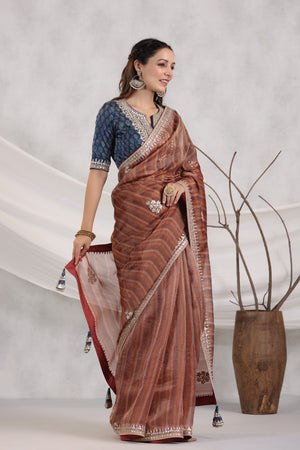 Buy brown striped organza saree online in USA with blue embroidered blouse. Make a fashion statement on festive occasions and weddings with designer suits, Indian dresses, Anarkali suits, palazzo suits, designer sarees, sharara suits, Bollywood saris from Pure Elegance Indian fashion store in USA.-side