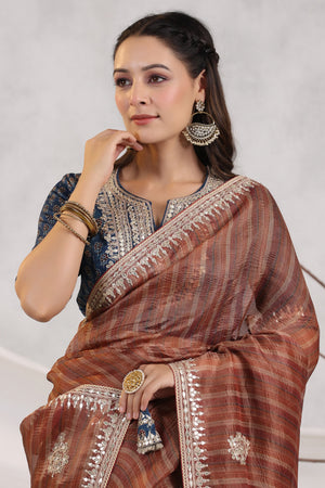 Buy brown striped organza saree online in USA with blue embroidered blouse. Make a fashion statement on festive occasions and weddings with designer suits, Indian dresses, Anarkali suits, palazzo suits, designer sarees, sharara suits, Bollywood saris from Pure Elegance Indian fashion store in USA.-closeup