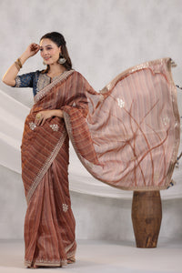 Buy brown striped organza saree online in USA with blue embroidered blouse. Make a fashion statement on festive occasions and weddings with designer suits, Indian dresses, Anarkali suits, palazzo suits, designer sarees, sharara suits, Bollywood saris from Pure Elegance Indian fashion store in USA.-full view