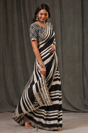 Shop black and white stripes crepe georgette saree online in USA with saree blouse. Look classy at weddings and special occasions in exquisite designer sarees, embroidered sarees, party sarees, handwoven saris, pure silk sarees, Banarasi sarees, Kanjivaram sarees from Pure Elegance Indian saree store in USA.-side