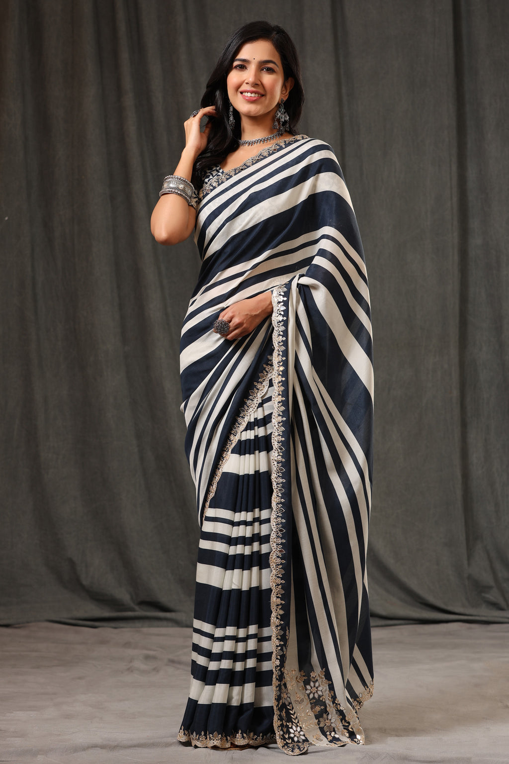Buy stunning black and white stripes crepe georgette sari online in USA with saree blouse. Look classy at weddings and special occasions in exquisite designer sarees, embroidered sarees, party sarees, handwoven saris, pure silk sarees, Banarasi sarees, Kanjivaram sarees from Pure Elegance Indian saree store in USA.-full view