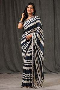 Buy stunning black and white stripes crepe georgette sari online in USA with saree blouse. Look classy at weddings and special occasions in exquisite designer sarees, embroidered sarees, party sarees, handwoven saris, pure silk sarees, Banarasi sarees, Kanjivaram sarees from Pure Elegance Indian saree store in USA.-full view