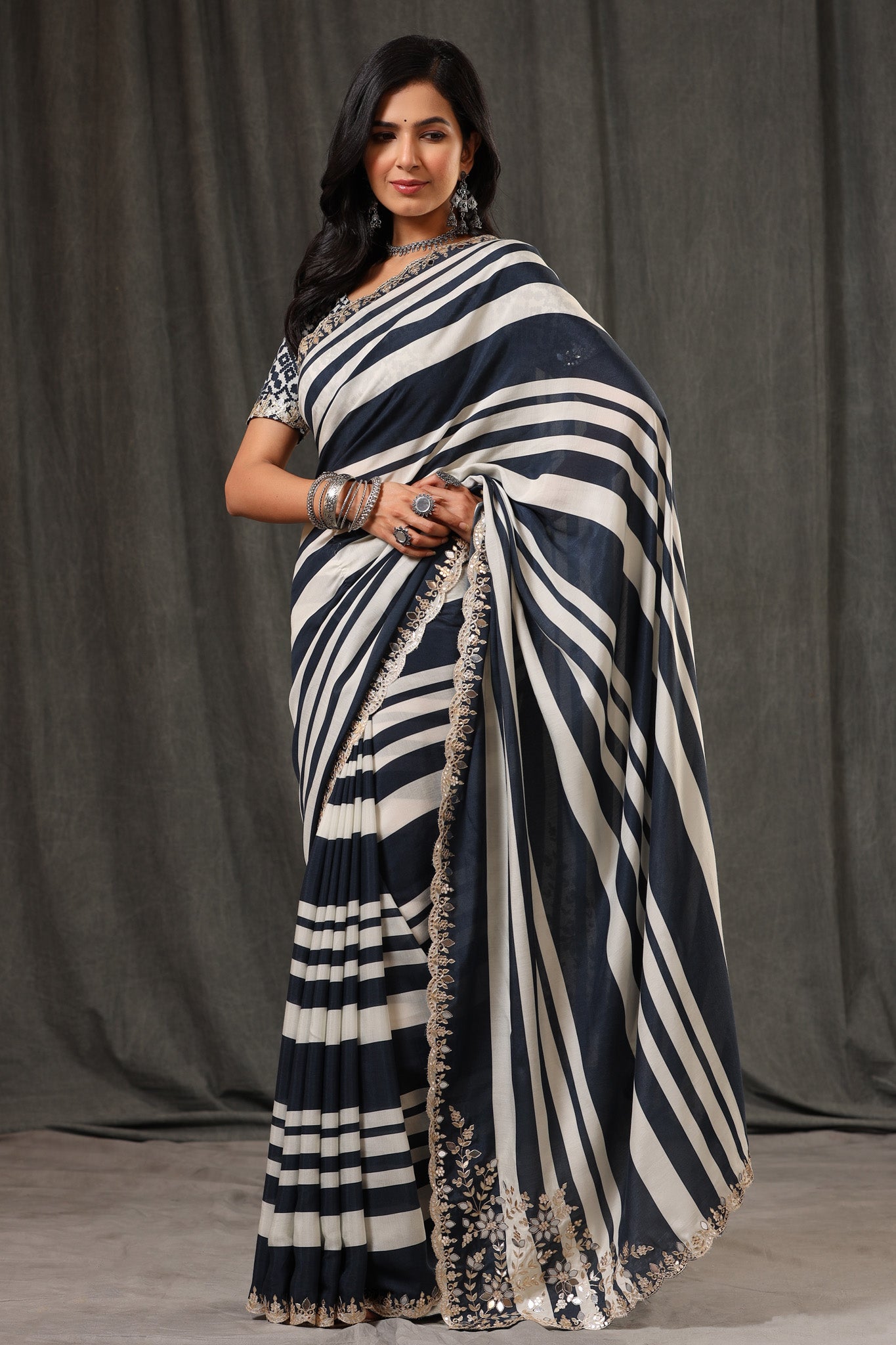Buy stunning black and white stripes crepe georgette sari online in USA with saree blouse. Look classy at weddings and special occasions in exquisite designer sarees, embroidered sarees, party sarees, handwoven saris, pure silk sarees, Banarasi sarees, Kanjivaram sarees from Pure Elegance Indian saree store in USA.-front